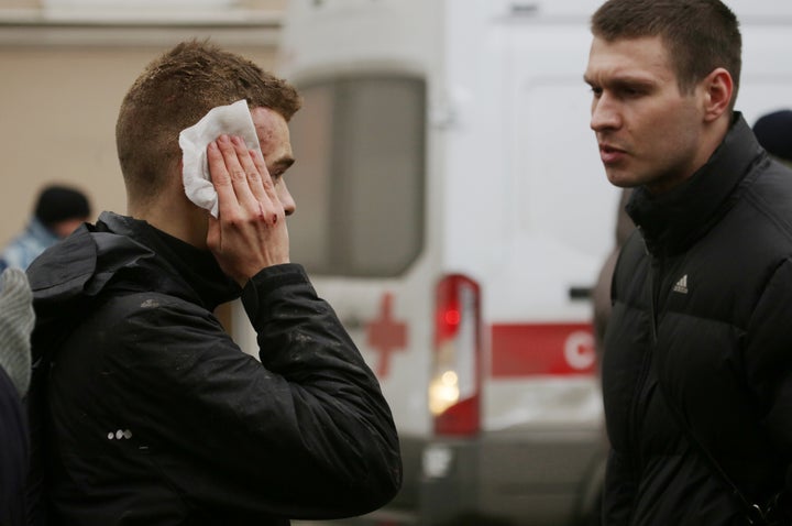 An injured person stands outside Sennaya Ploshchad metro station, following explosions in two train carriages at metro stations in St. Petersburg, Russia April 3, 2017.