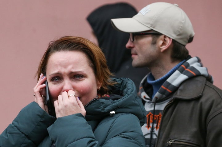 A woman weeps while talking on the mobile phone at the entrance to Tekhnologichesky Institut station