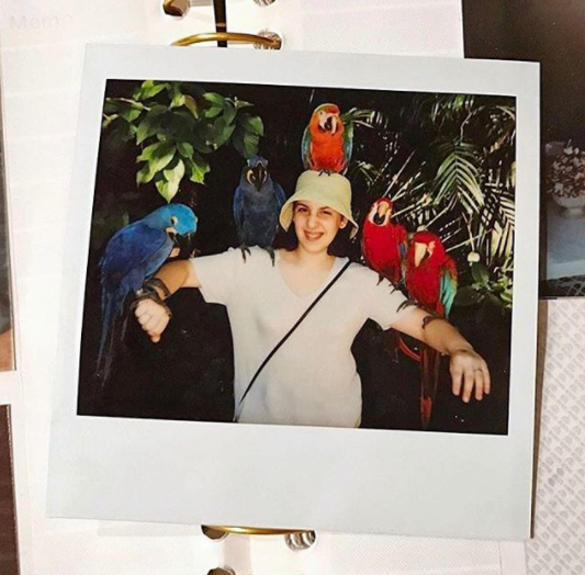 "What a beautiful day don't you wish you were holding some parrots while wearing a bucket hat?" she wrote on Insta.