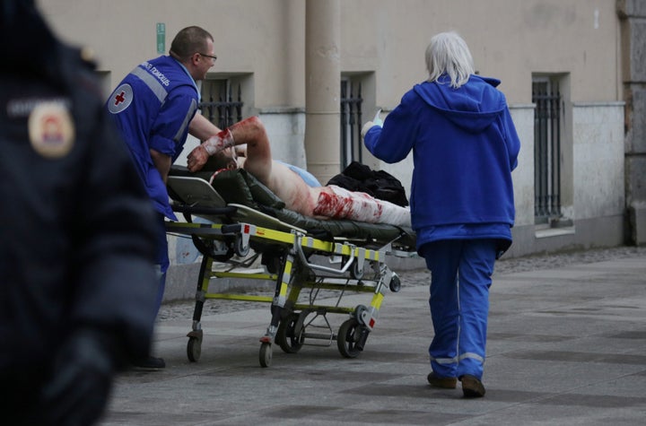 An injured person is helped by emergency services outside Sennaya Ploshchad metro station