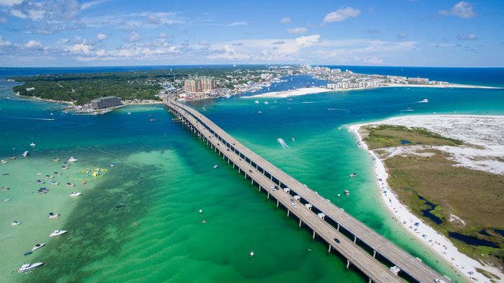 The teen was swimming near a sandbar off Destin's coast (pictured). Locals have shared stories online of seeing sharks off a nearby bridge.