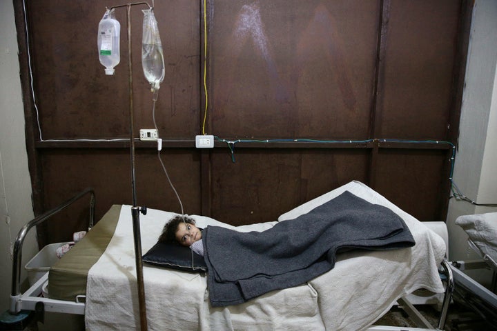 A girl rests in a field hospital in Harasta, after an airstrike hit a kindergarten in November 2016. 