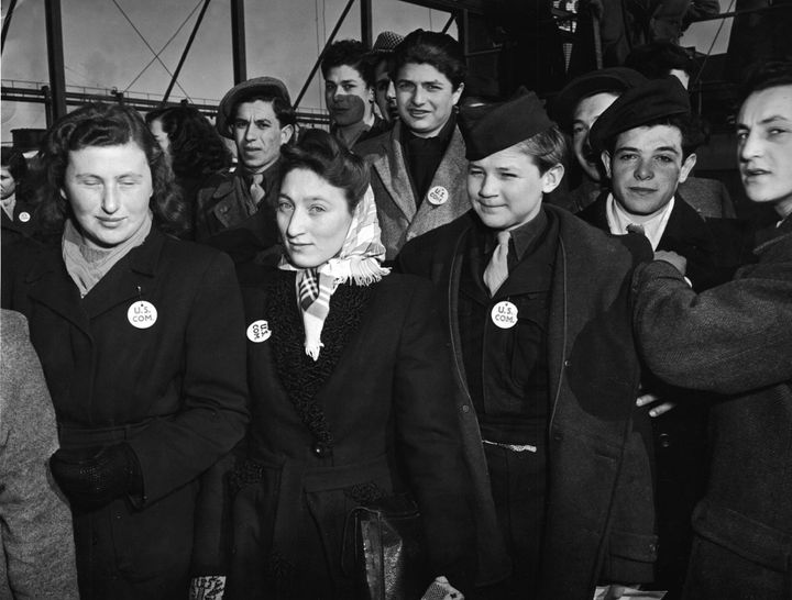 A group of children and young adults stand on the deck of the S.S. Marine Perch as it arrives in the United States bringing immigrants and World War II refugees from Europe to New York circa February 1947.