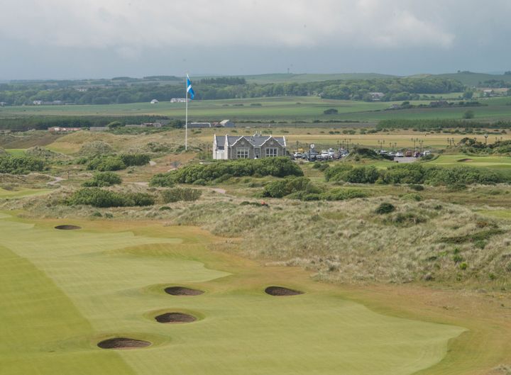 Trump's International Golf Links course clubhouse is pictured behind the 18th hole, north of Aberdeen on the east coast of Scotland