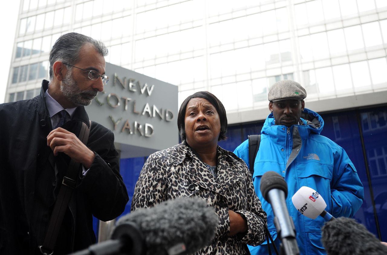 Doreen Lawrence, the mother of murdered teenager Stephen Lawrence, talks to the media, with her son Stuart (right) and Imran Khan (left) from her legal team outside New Scotland Yard, central London, following a meeting with Metropolitan Police Commissioner Sir Bernard Hogan-Howe, to discuss claims that undercover police officers hunted for information to smear her family.