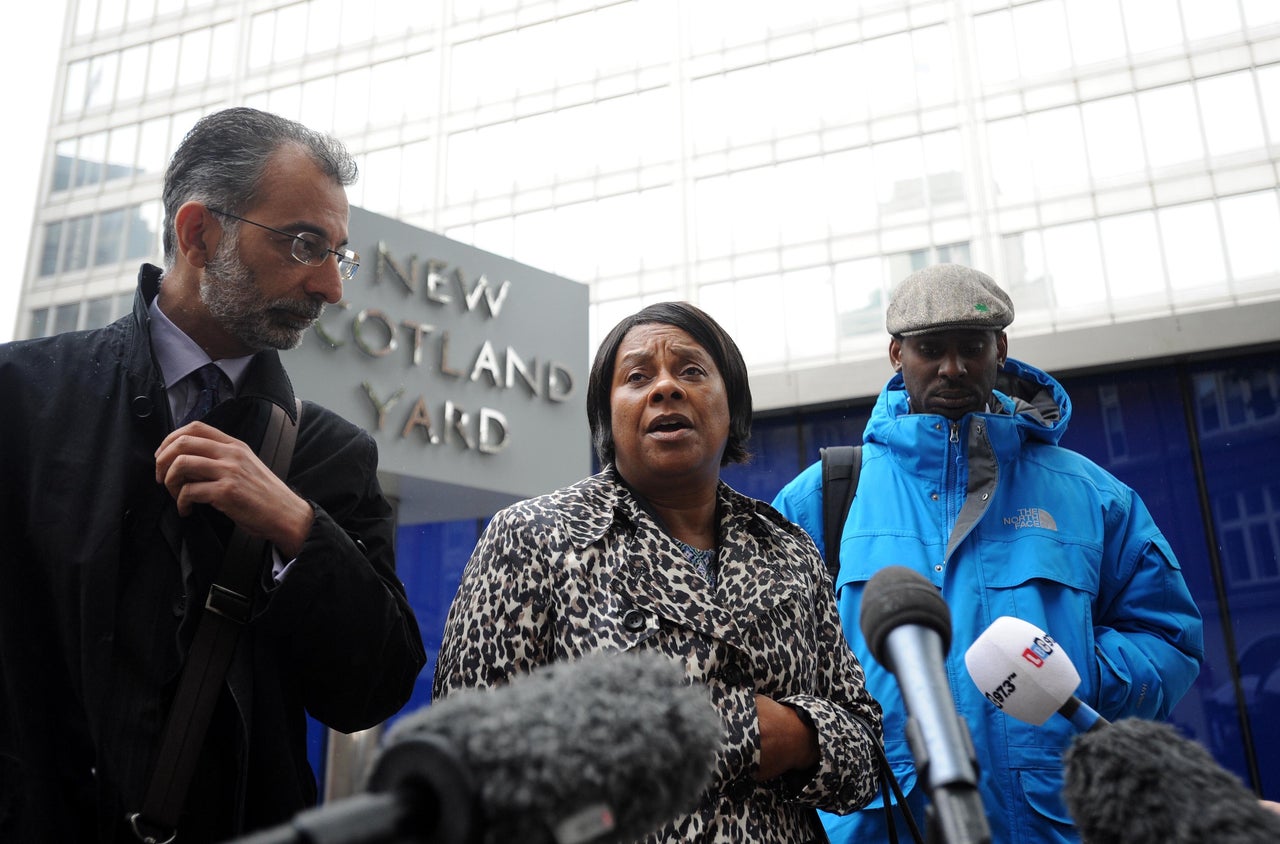 <strong>Doreen Lawrence, the mother of murdered teenager Stephen Lawrence, talks to the media, with her son Stuart (right) and Imran Khan (left) from her legal team outside New Scotland Yard, central London, following a meeting with Metropolitan Police Commissioner Sir Bernard Hogan-Howe, to discuss claims that undercover police officers hunted for information to smear her family.</strong>