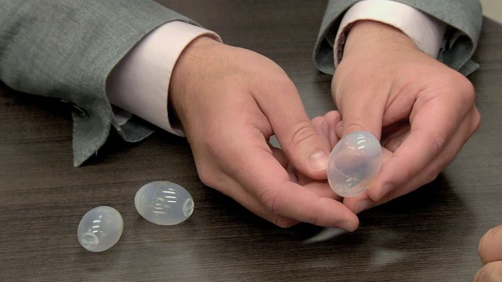 Dr. Dean Elterman displays the size options of testicular implants. 