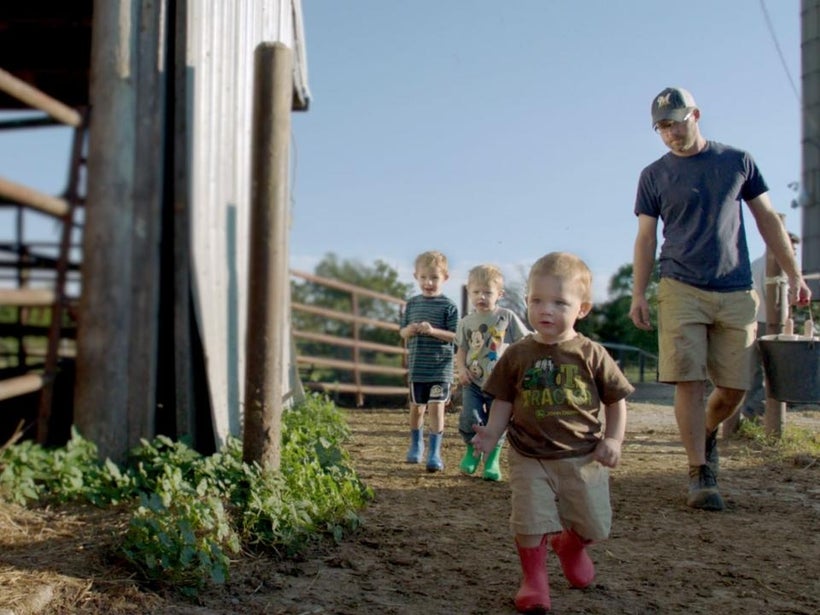 Dan Lauderdale on the farm with three of his four sons.
