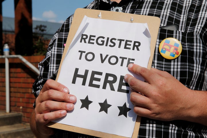 A man holds voter registration forms outside a campaign rally with 2016 Democratic presidential candidate Hillary Clinton in Greensboro, North Carolina.