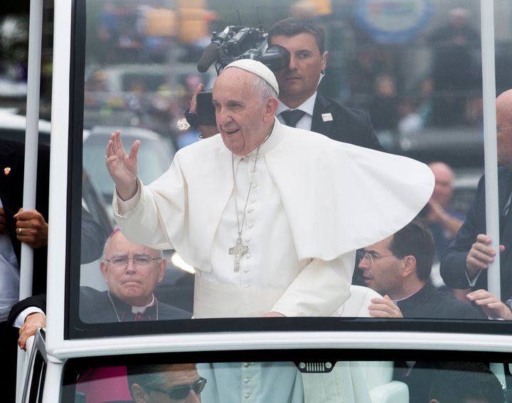 Pope Francis waves to pilgrims on the Benjamin Franklin Parkway in Philadelphia on Sunday, Sept. 27, 2015.