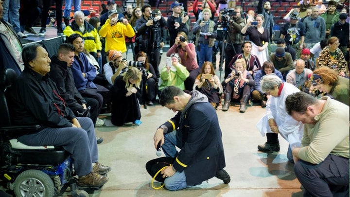 <p>Lt. Wesley Clark Jr. kneels in front of Chief Leonard Crow Dog during the “Forgiveness Ceremony.”</p>
