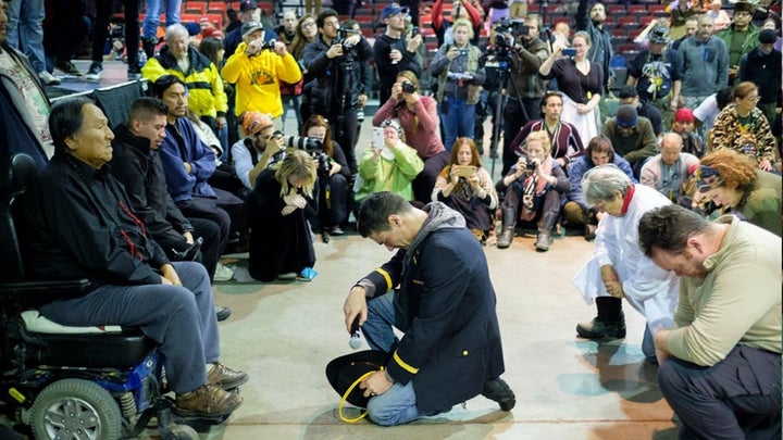 Lt. Wesley Clark Jr. kneels in front of Chief Leonard Crow Dog during the “Forgiveness Ceremony.”