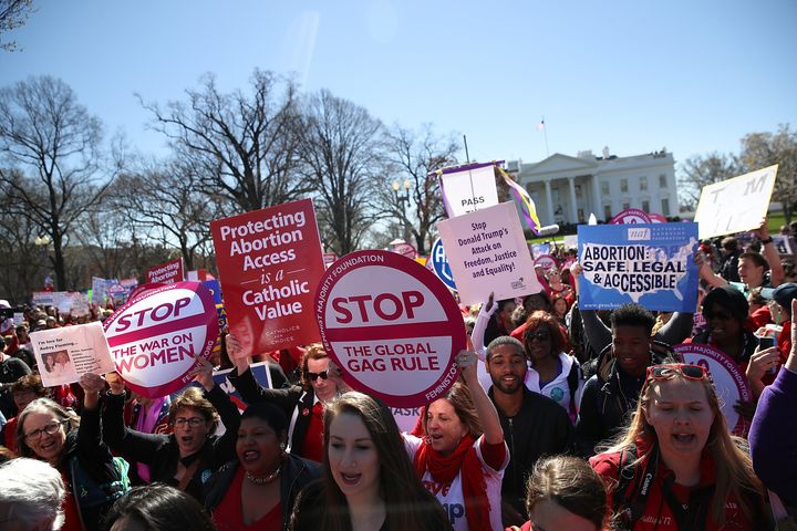 Protesters march by the White House during a rally to support women's health programs on March 8, 2017 in Washington.