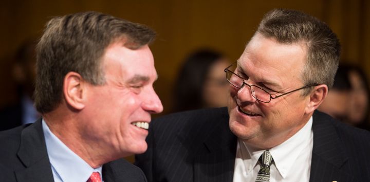 Democratic Sens. Mark Warner of Virginia, left, and Jon Tester of Montana are among those backing the nomination of a former Goldman Sachs bailout lawyer to head the Securities and Exchange Commission.