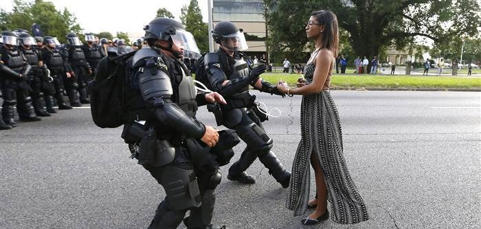 <p>Black Lives Matter activist, Ieshia Evans, remaining calm while walking up to a line of riot police Baton Rouge, Louisiana.</p>