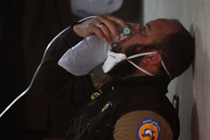 A civil defence member breathes through an oxygen mask after a suspected gas attack on Tuesday.