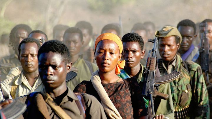 <p>One lone woman stands out surrounded by men during her march with Ethiopia’a Oromo Liberation Front (OLF), a national self-determination organization that has worked to stop atrocity against rural ethnics inside Ethiopia beginning as far back as 1973. Today the Ethiopian government continues to classify the OLF as a terrorist organization. In this image the look on this unnamed woman’s face says “a-thousand-words.” Image: Jonathan Alpeyrie/Wikimedia Commons </p>