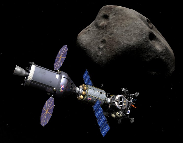 In this illustration, a manned asteroid lander is docked to a combination Deep Space Vehicle and Extended Stay Module on a mi