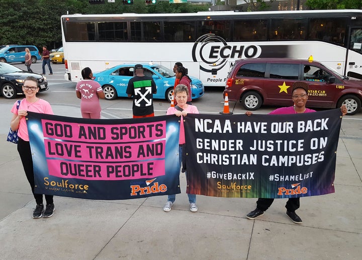 Soulforce activists Haven Herrin, Beth Mims, and D.J. Hudson receive hi-fives from fans as they show off the banners that got the group threatened with criminal trespass and ejected from the American Airlines Center at the Final Four in Dallas. 