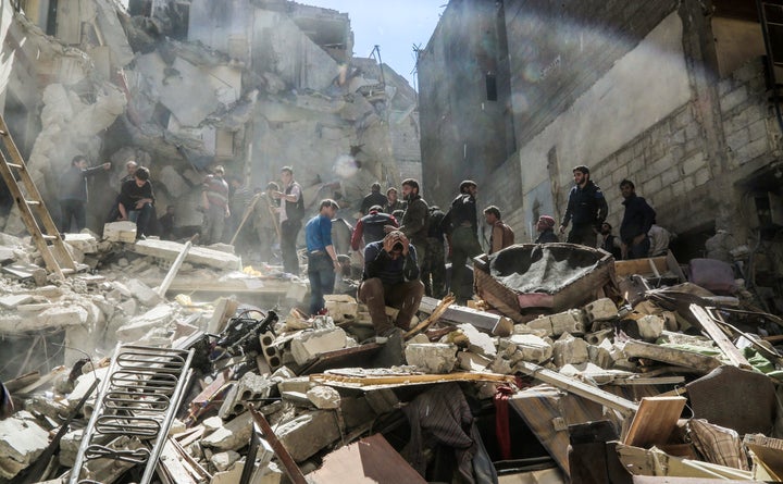 A Syrian mourns as members of the White Helmets search for survivors of an air raid on 4 April