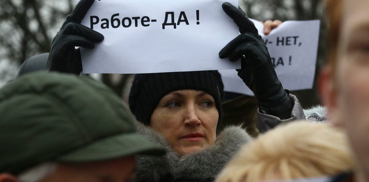 A woman holds a placard reading “No to decree, yes to work!” in the town of Bobruisk in Belarus on March 12 2017.