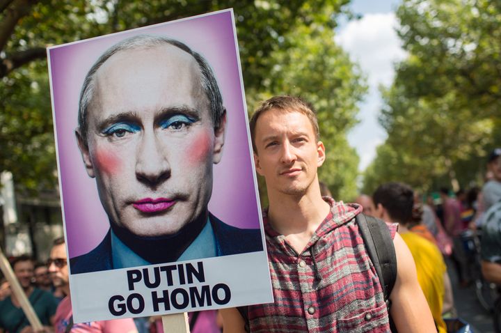 A man holds up a sign reading 'Putin go homo' in Berlin on August 31, 2013