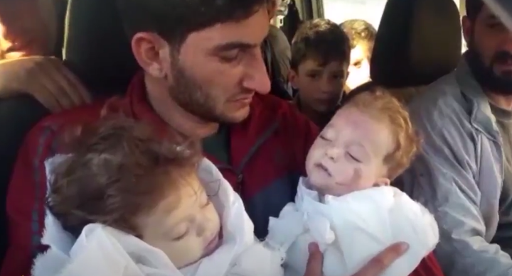 In a video, father Abdel Hameed Alyousef carries his twin daughters who were killed in the gas attack in the province of Idlib earlier this week.