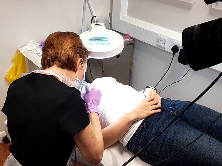 Claire tattooing a client.