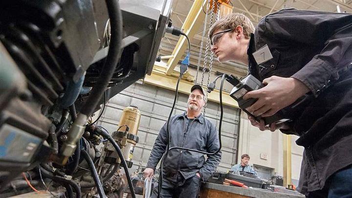 A Virginia high school junior tries to diagnose an engine problem. Many states want to expand career and technical training in secondary schools, but face a lack of qualified teachers.