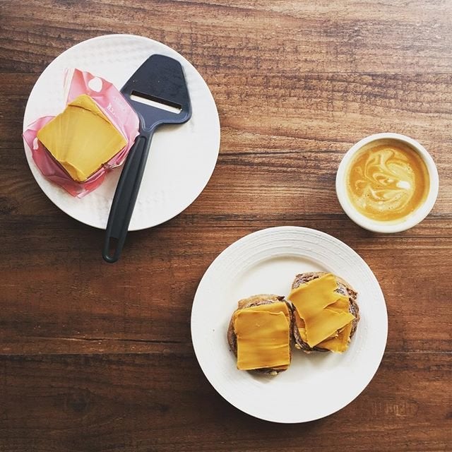 Coffee and brunost cheese slices on bread.