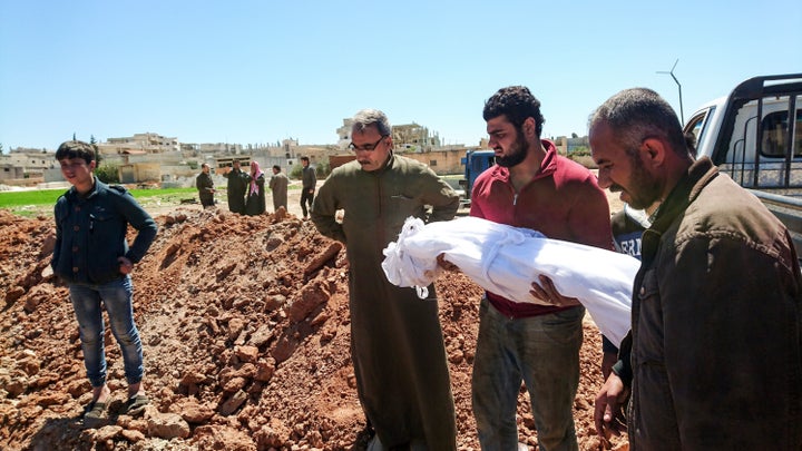 Syrians bury the bodies of victims of a a suspected toxic gas attack in Khan Sheikhun, a nearby rebel-held town in Syrias northwestern Idlib province, on April 5, 2017.