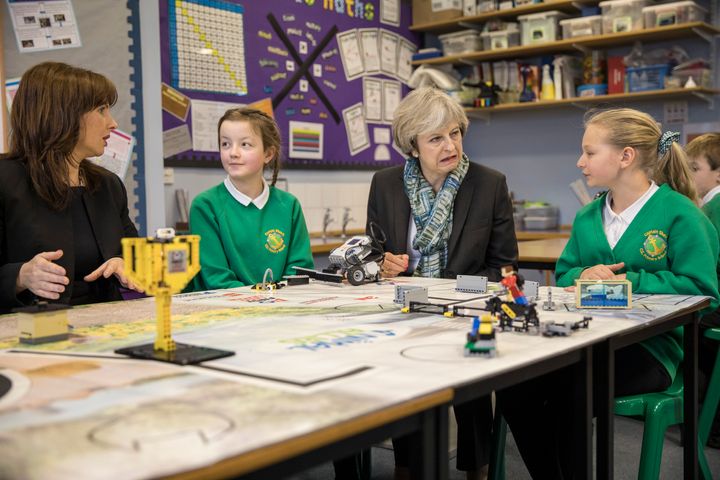 Theresa May sits with year six pupils during a visit to Captain Shaw's Primary School in Bootle, Cumbria during the Copeland by-election campaign