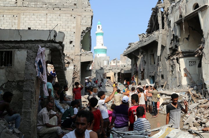 Yemenis gather on September 22, 2016 amidst the rubble of buildings destroyed during Saudi-led air strikes in the rebel-held Yemeni port city of Hodeida the previous day.