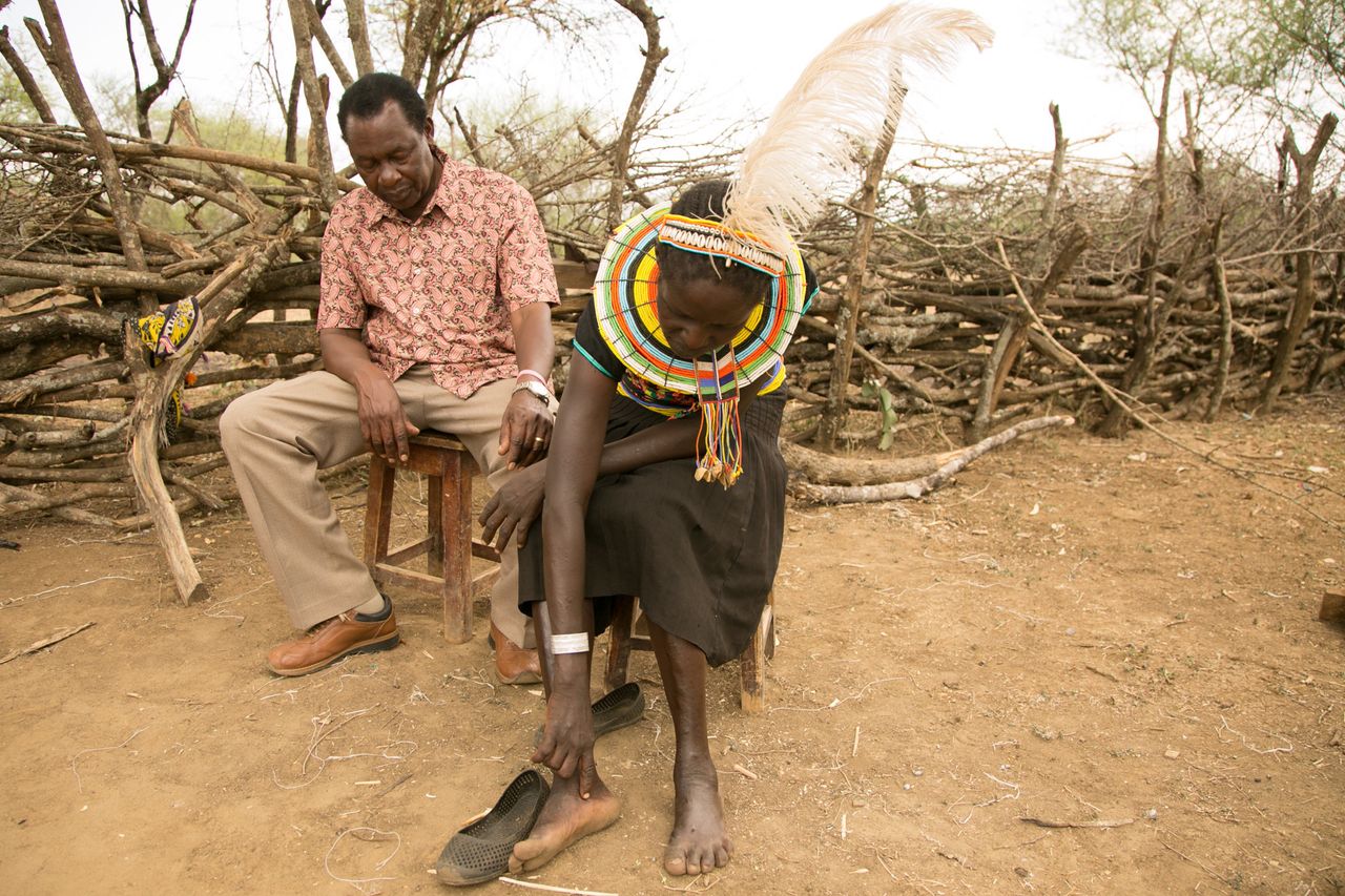 Cheposait Adomo, seated with Dr. Michael Makari, head of Kacheliba hospital in Kenya's West Pokot, describes how she was bitten repeatedly by a black mamba.