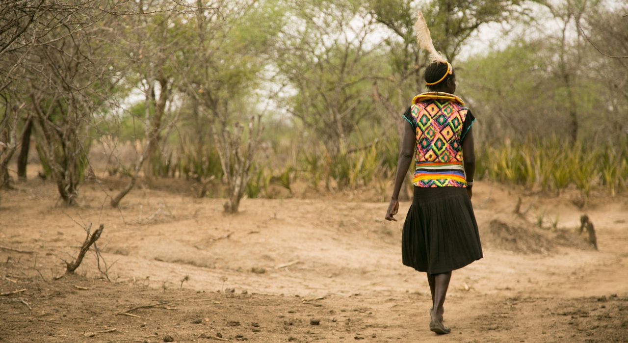 Cheposait Adomo walks in the bush in Kenya's West Pokot near where she was bitten repeatedly by a snake.