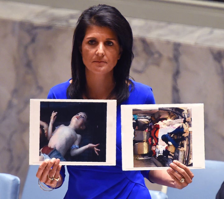 U.N. Ambassador Nikki Haley holding photos of the victims of a chemical weapons attack in Syria, urging the international community to push back against the Assad regime.