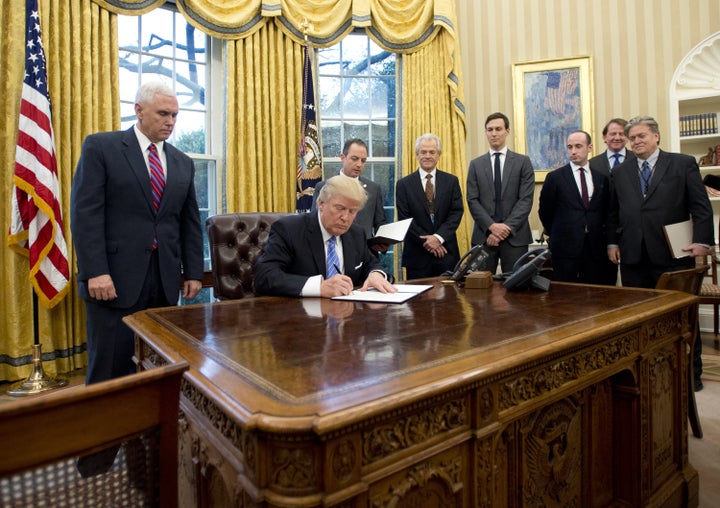 Donald Trump surrounded by men.