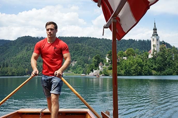 Rowing a Pletna boat on Lake Bled, Slovenia.