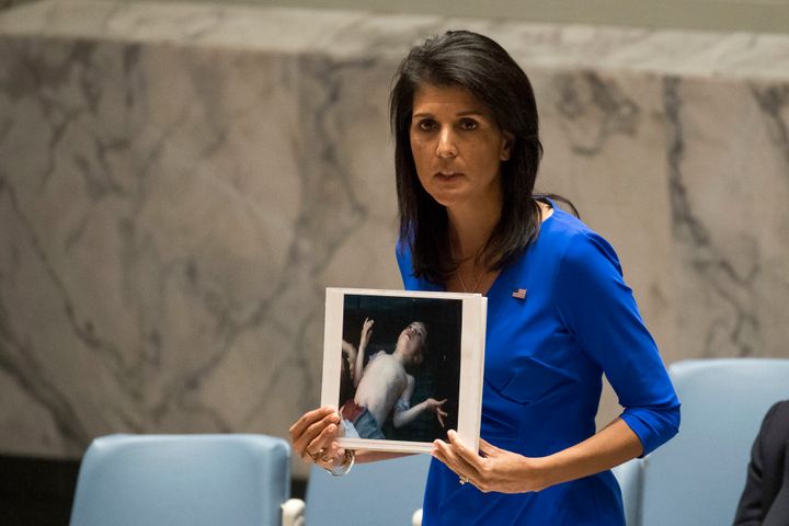 US ambassador to UN Nikki Hayley holding photo of a victim of the chemical attack
