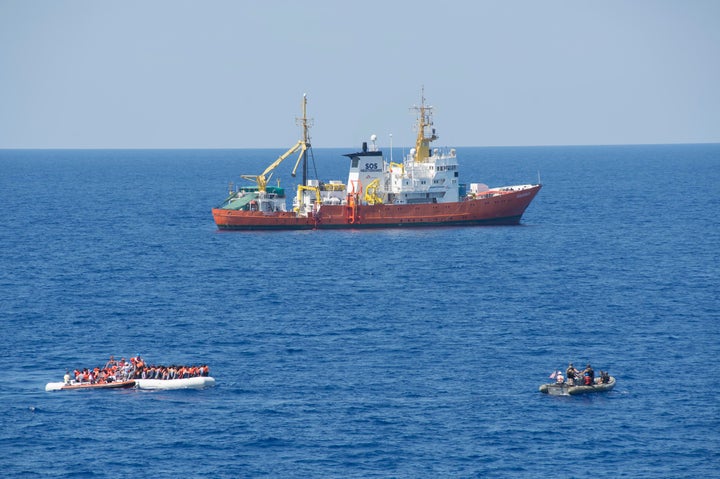 <p>Members of the SOS Mediterranean ship MS Aquarius rescue migrants on a small craft in the Mediterranean Sea. July 29, 2016.</p>