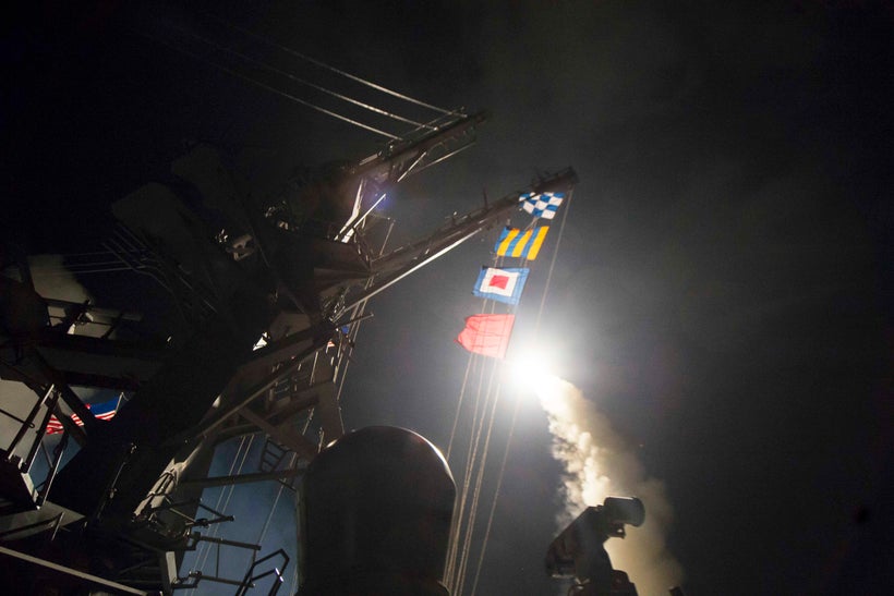 The Arleigh Burke-class guided-missile destroyer USS Ross fires a Tomahawk land-attack missile while conducting naval operati