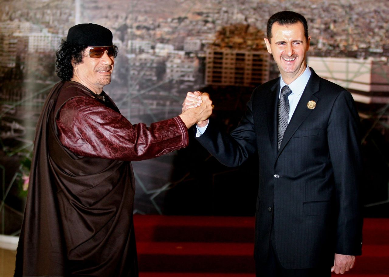 Syrian President Bashar Assad joins hands with then Libyan leader Muammar Gaddafi. Damascus, Syria. March 29, 2008.