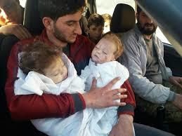 <p>a father cradles his twins, murdered by the Assad regime with Sarin gas</p>