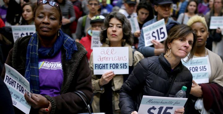 Women take part in a National Day of Action 15 dollar per hour minimum wage protest at the Massachusetts State House in Boston on Nov. 29, 2016.