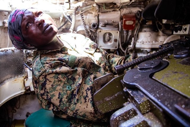 Based at the Arabiska Forward Operating Base in south-central Somalia, Corporal Stella Rose Ahinga, seen here taking instruction from her tank commander during afternoon drills, is one of a growing number of African women joining the ranks of military and police.