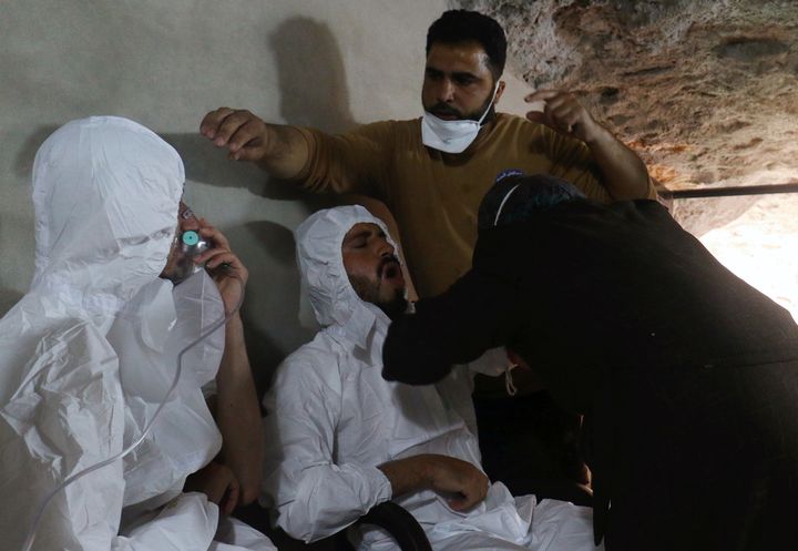 A man breathes through an oxygen mask as another one receives treatments, after what rescue workers described as a suspected gas attack in the town of Khan Sheikhoun in rebel-held Idlib, Syria April 4, 2017.