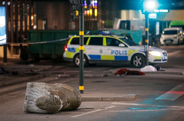 A turned over, 'Stockholmslejon', a concrete traffic stopper, is seen outside the roped off area near the department store Ah