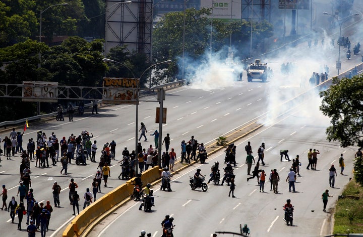 Demonstrators clash with riot police during a rally in Caracas. 