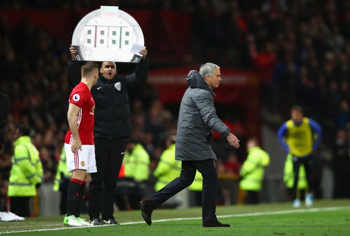 Jose Mourinho approaches the pitch as defender Luke Shaw prepares to come on for United against Everton.