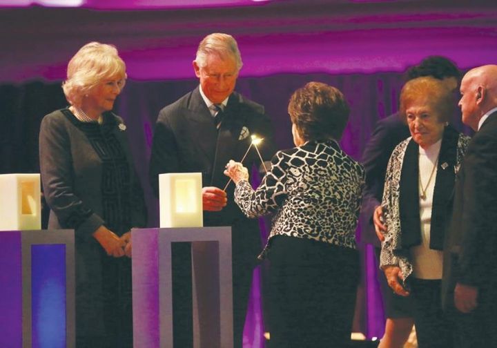 PRINCE CHARLES AND A HOLOCAUST SURVIVOR LIGHT A CANDLE AT CENTRAL HALL WESTMINSTER